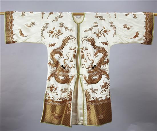 A Chinese cream silk and gilt couch work dragon robe, early 20th century, length 96cm